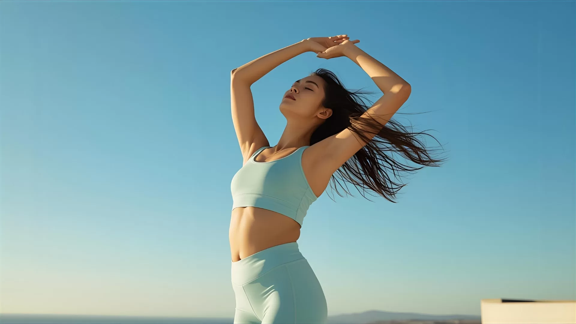 Woman in activewear doing yoga outdoors.