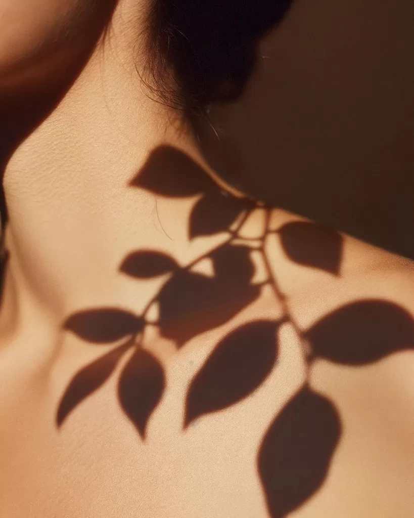 Temporary tattoo of petals on human back.