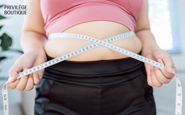 Person measuring waist with a tape measure.