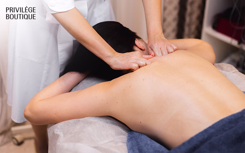 Therapist performing a deep tissue Meridian massage on woman's back.