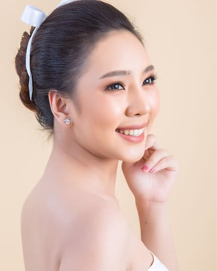 Woman applying lipstick and skincare mask.