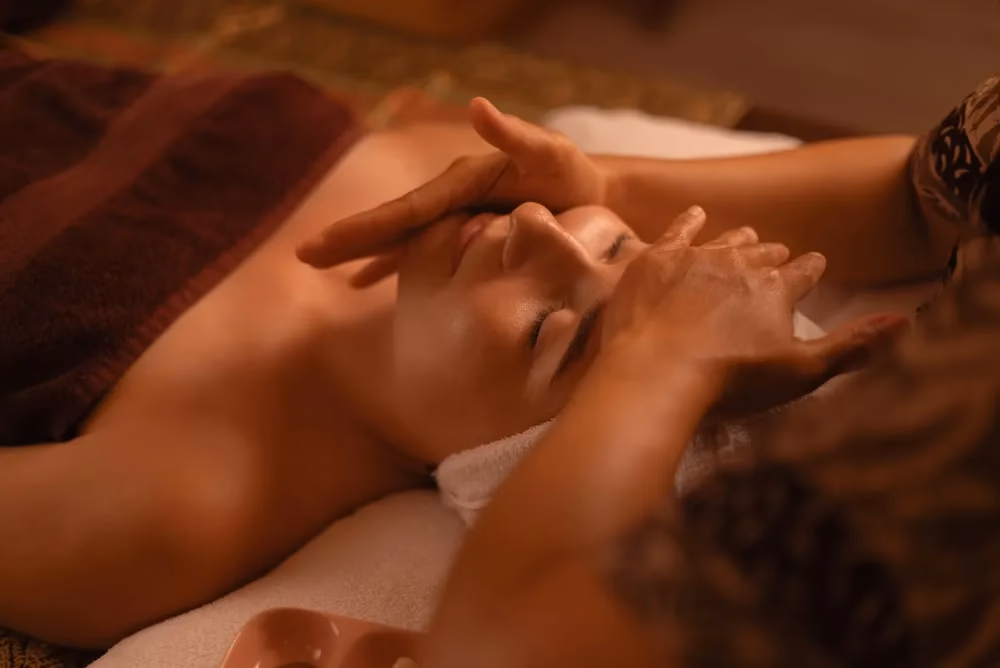 Woman receiving a relaxing facial treatment in a spa setting.