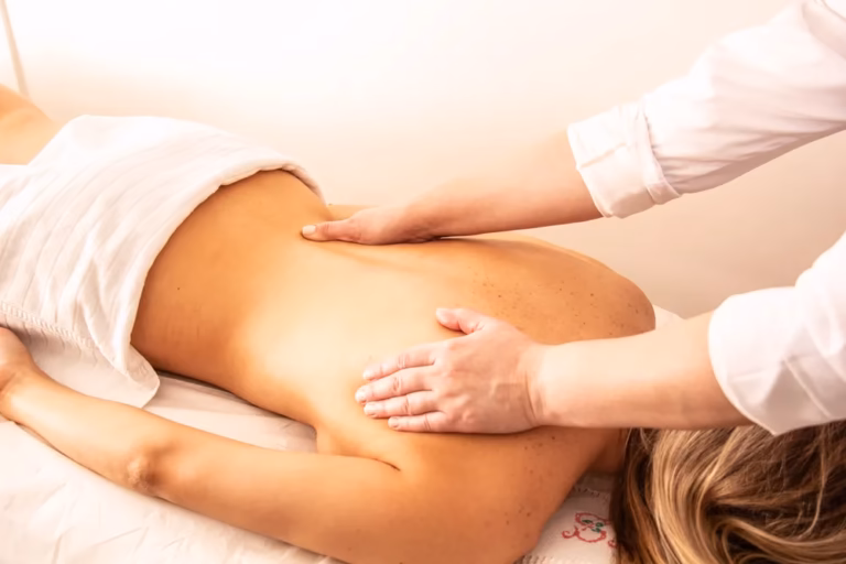 A woman receiving a back massage at a spa
